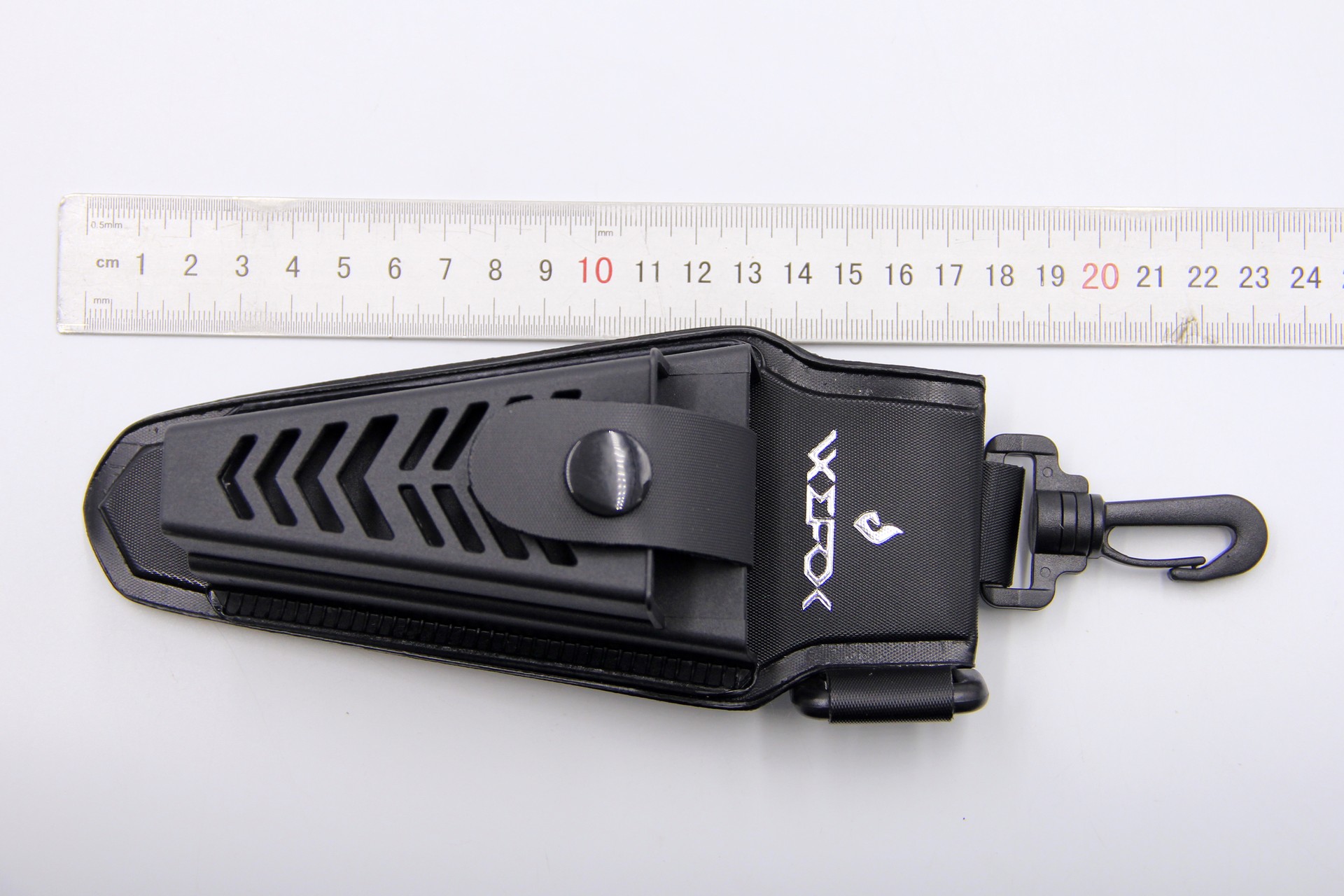 Top-down product photo of a black WEFOX EVA plier pouch with chevron-patterned molded front panel, snap-button closure strap, embossed brand logo, and swivel clip attachment, displayed alongside a metal ruler showing approximately 20cm in total length.