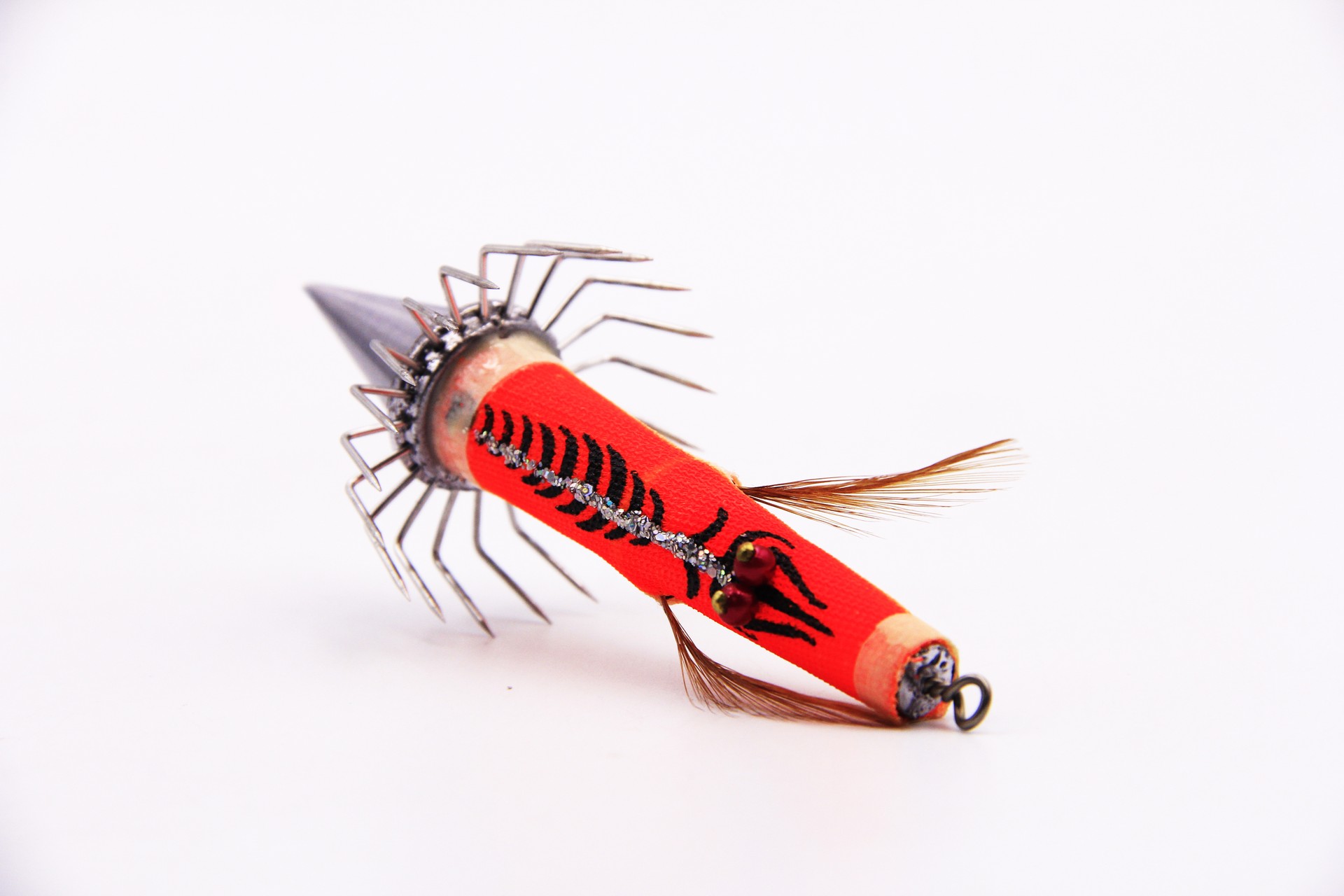 Red Bocean Candat Twist Squid Jig Bottom Sinker with sharp umbrella hooks, cone sinker body, and feather skirt on white background.