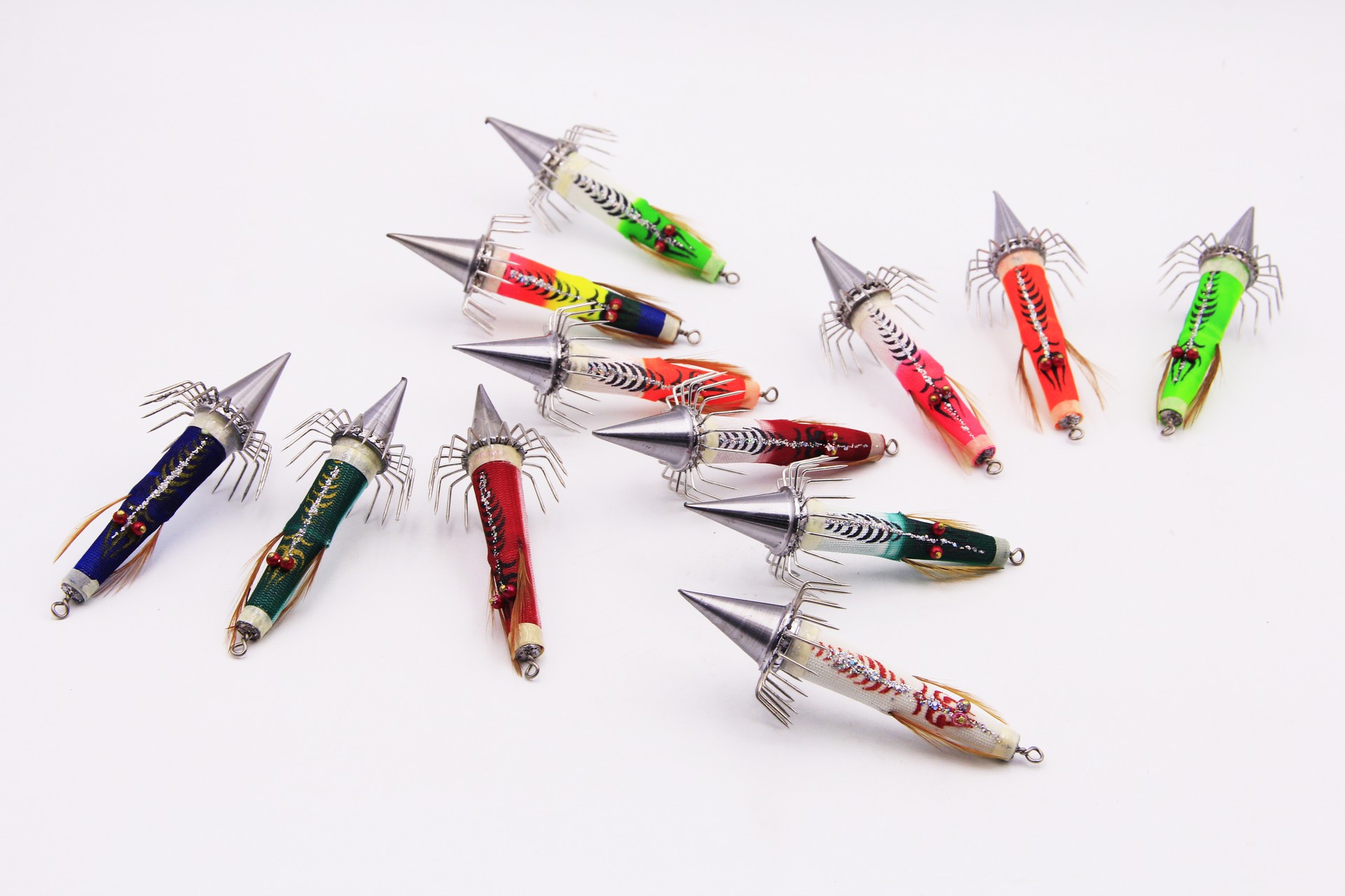 12 colorful Bocean Candat Twist Squid Jig Bottom Sinkers with luminous cone bodies and umbrella squid hooks on white background