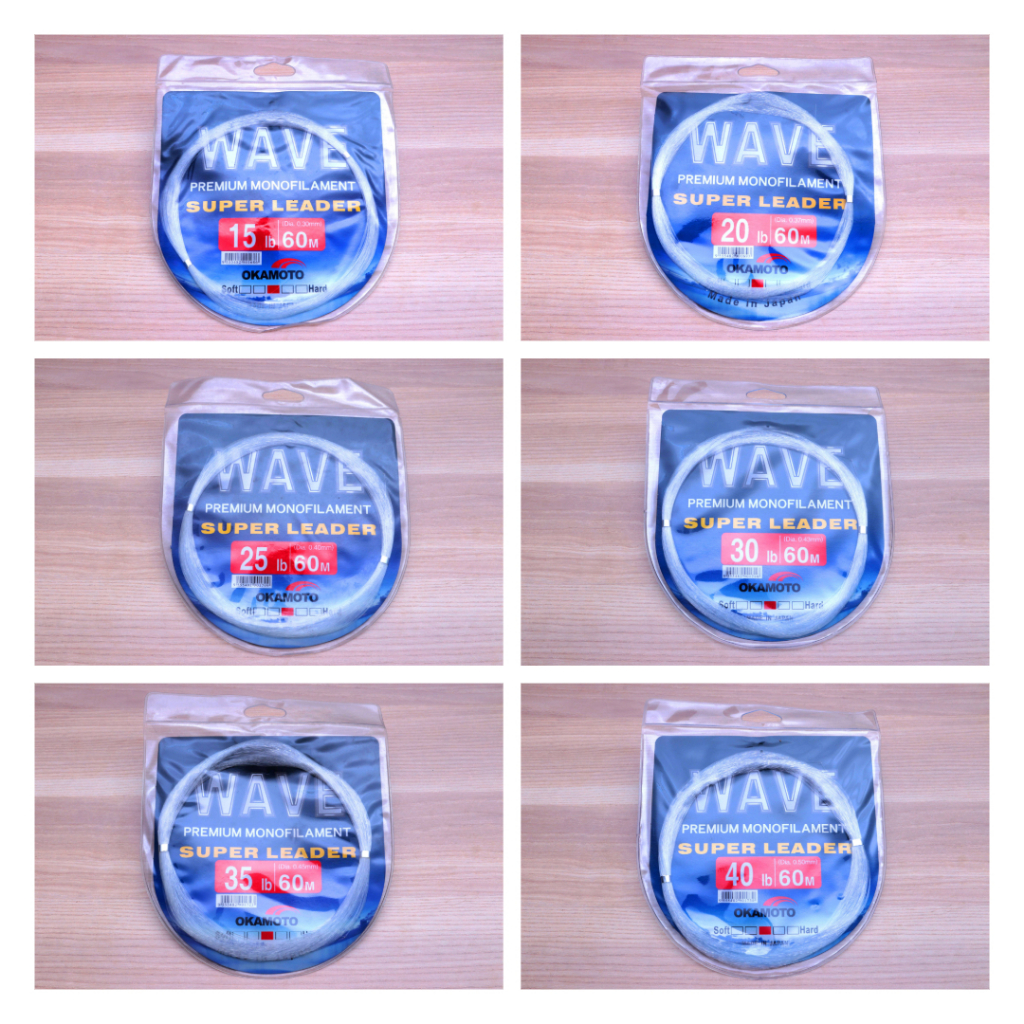 Six Okamoto Wave Super Soft Leader premium monofilament leader line in 15-50lb to 40-60lb strengths arranged on wooden table.