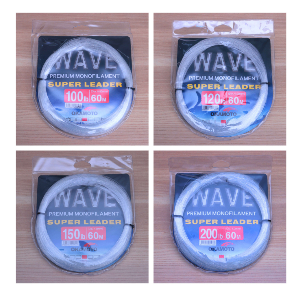 Okamoto Wave Super Soft Leader premium monofilament spools in 100lb/60m, 120lb/60m, 150lb/60m, 200lb/60m on wood table.