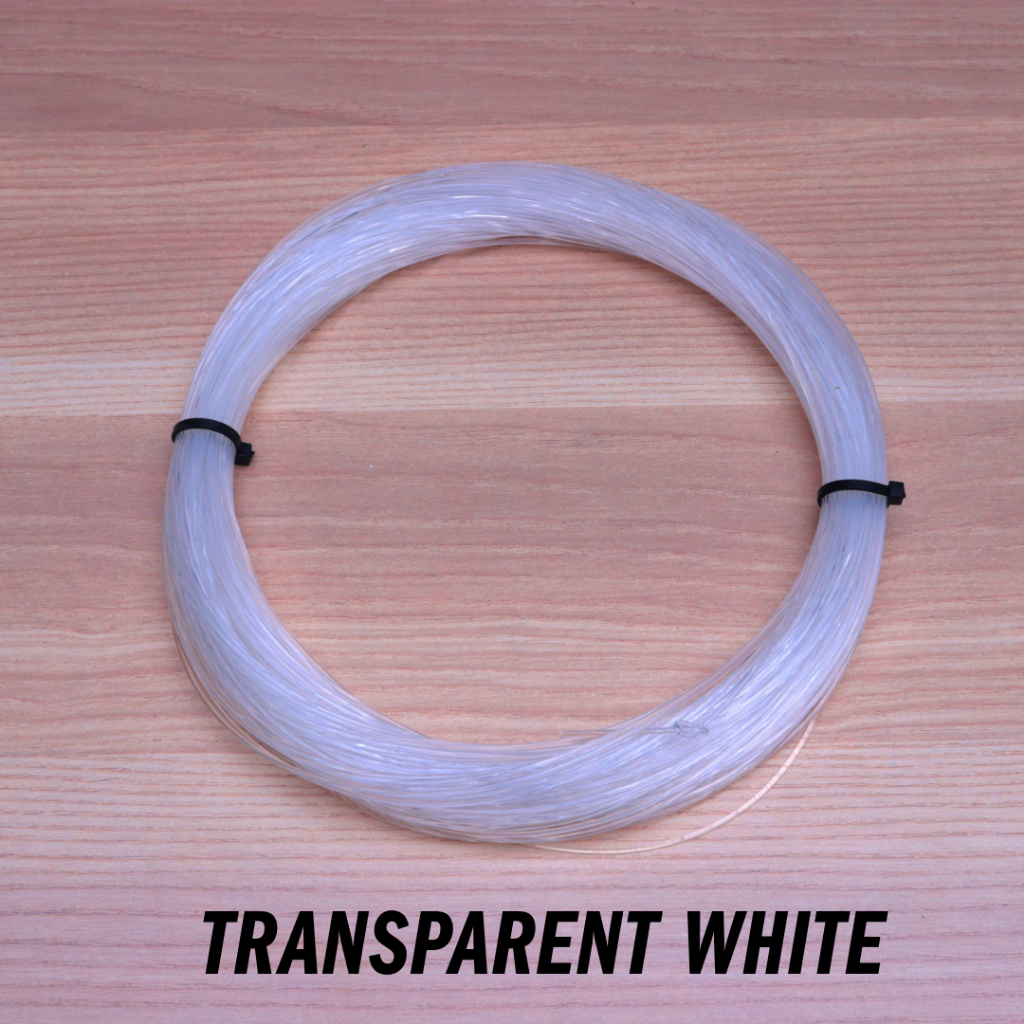 Okamoto Wave Super Soft Leader transparent white monofilament spool on wood table, secured by black bands.